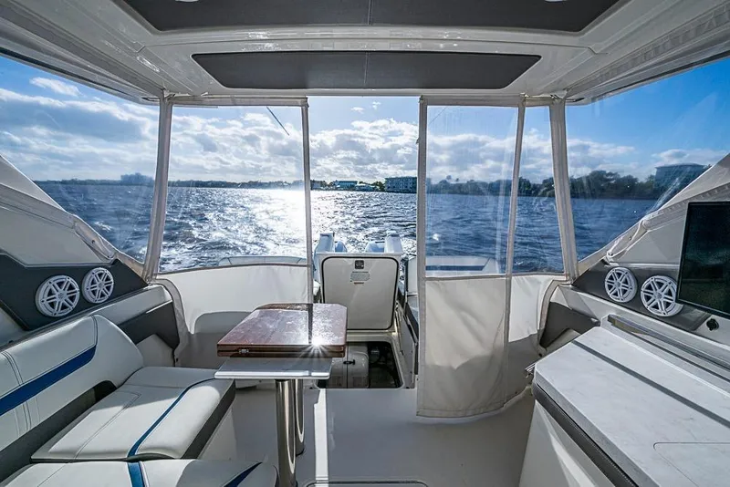 Slide: The Image of Interior of 2022 Tiara Yachts 34 LX, featuring helm, seating, and entertainment system. - 32