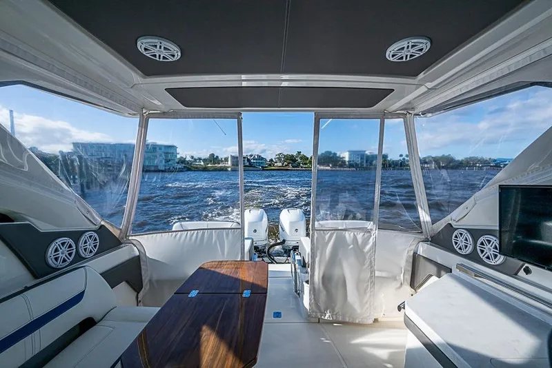 Slide: The Image of Interior view of 2022 Tiara Yachts 34 LX, featuring luxurious seating and scenic water backdrop. - 33