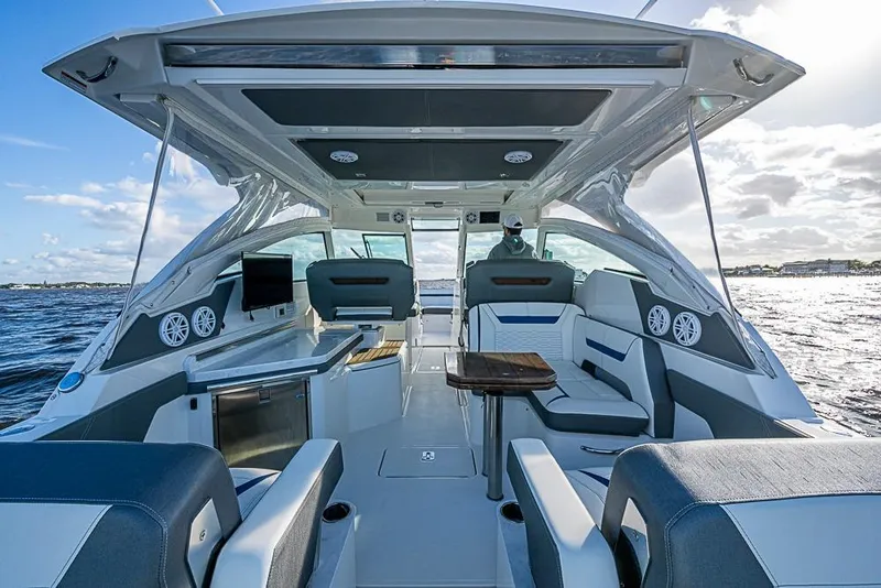 Slide: The Image of Interior view of 2022 Tiara Yachts 34 LX, featuring luxurious seating and scenic water backdrop. - 34