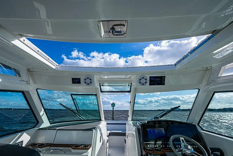 Slide: The Image of 2022 Tiara Yachts 34 LX interior with seating, table, and ocean view. - 35