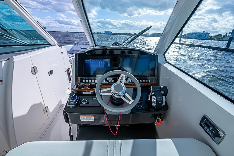 Slide: The Image of 2022 Tiara Yachts 34 LX helm with modern controls and scenic water view. - 41