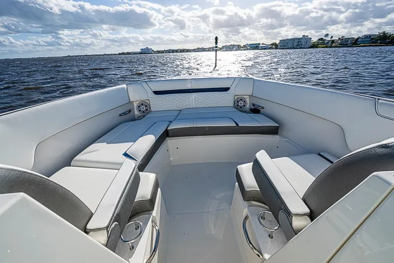 Slide: The Image of 2022 Tiara Yachts 34 LX luxury boat interior with white seating and ocean view. - 46
