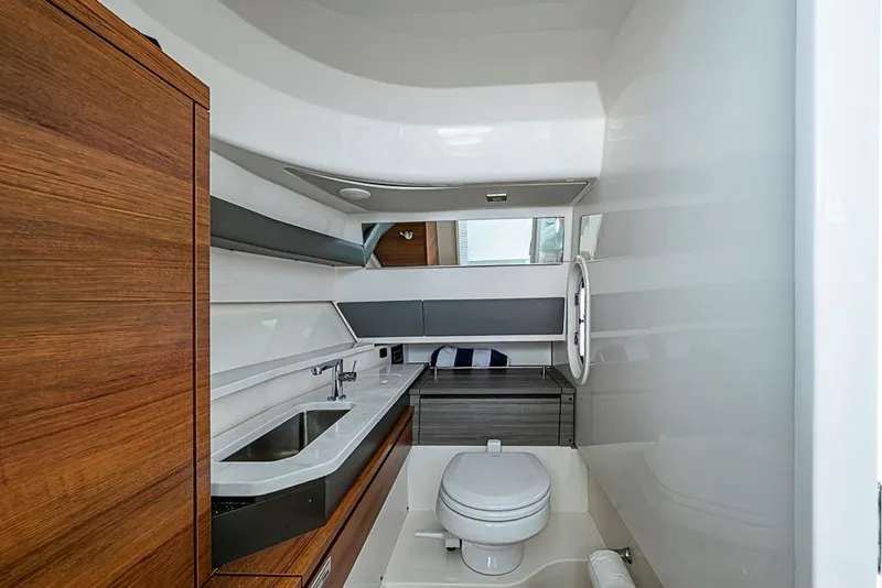 Slide: The Image of 2022 Tiara Yachts 34 LX bow storage compartment open on a sunny day. - 48