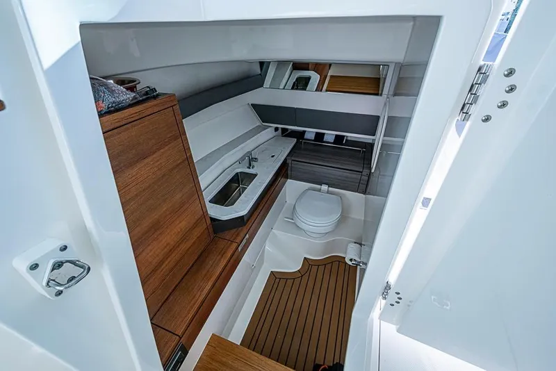 Slide: The Image of Luxurious 2022 Tiara Yachts 34 LX bathroom with modern fixtures and wood accents. - 49