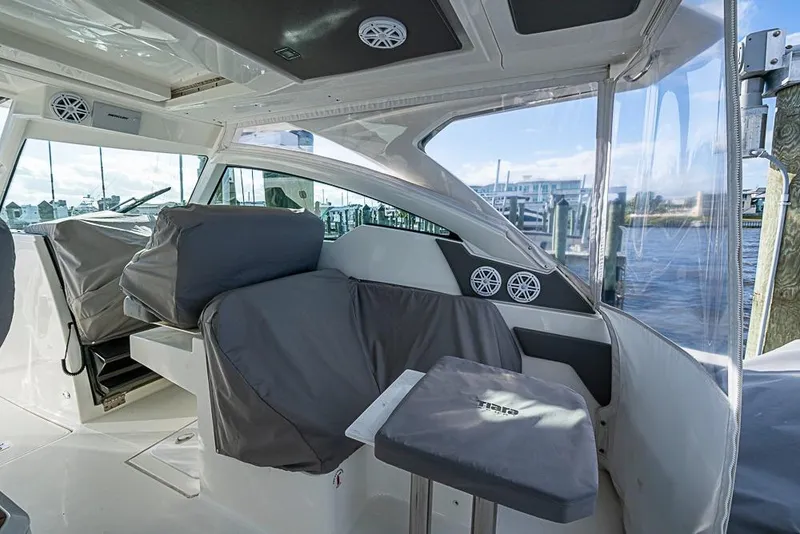 Slide: The Image of 2022 Tiara Yachts 34 LX boat docked, covered seating area, sunny day, waterfront view. - 54