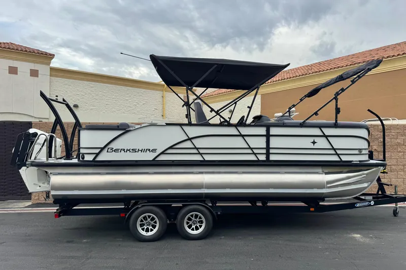 The Image of 2026 Berkshire 21CL STS pontoon boat on trailer, parked outdoors. - 0