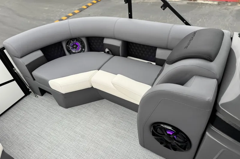 Slide: The Image of Luxurious seating in the 2026 Berkshire 21CL STS pontoon boat, featuring modern design and speakers. - 13