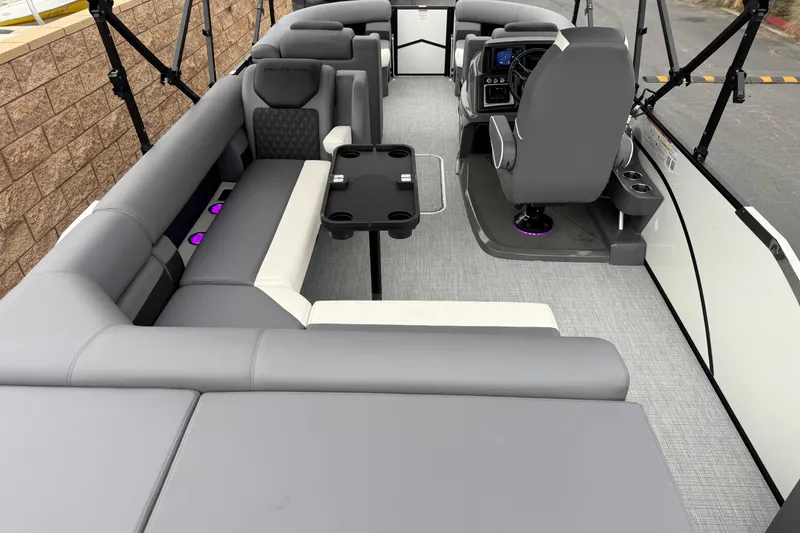 Slide: The Image of 2026 Berkshire 21CL STS pontoon boat interior with gray seating and modern helm. - 23
