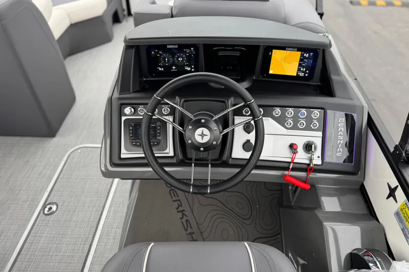 Slide: The Image of 2026 Berkshire 21CL STS boat dashboard with steering wheel and digital displays. - 26