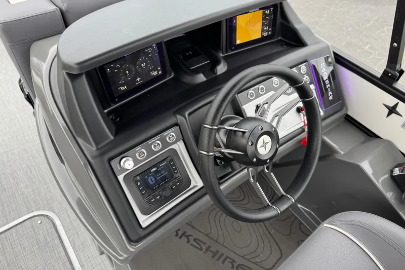 Slide: The Image of Steering console of 2026 Berkshire 21CL STS boat with modern controls and displays. - 27