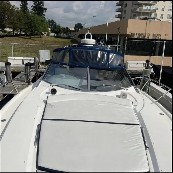 Slide: The Image of 2003 Sunseeker Portofino 46 yacht docked at marina, featuring sleek design and spacious deck. - 28