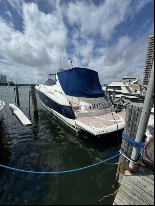 Slide: The Image of 2003 Sunseeker Portofino 46 yacht docked at marina under cloudy sky. - 3