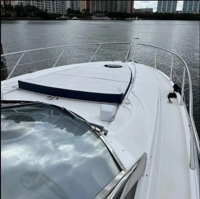 Slide: The Image of 2003 Sunseeker Portofino 46 yacht on calm water, showcasing sleek deck design. - 30