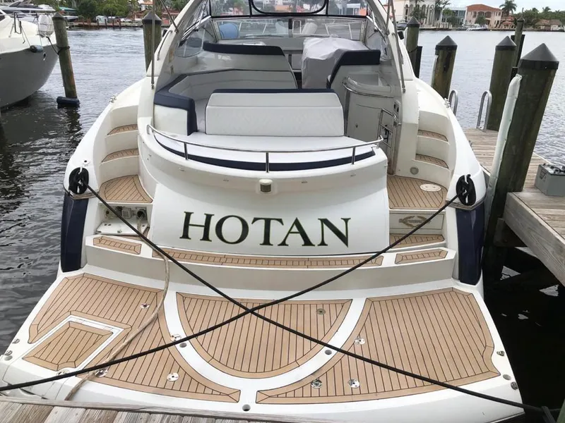 Slide: The Image of 2003 Sunseeker Portofino 46 yacht docked, featuring spacious deck and elegant design. - 5