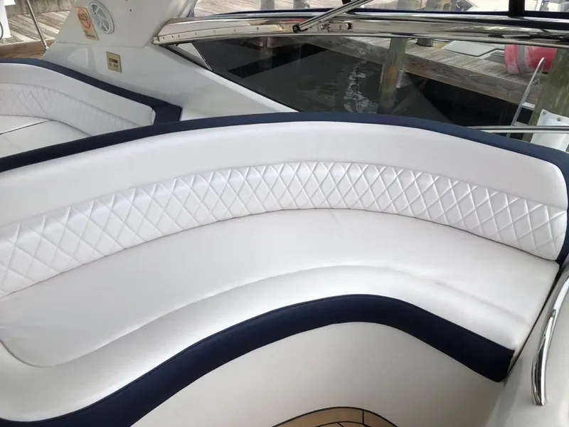 Slide: The Image of Luxurious white seating on 2003 Sunseeker Portofino 46 yacht, featuring diamond-pattern upholstery. - 9