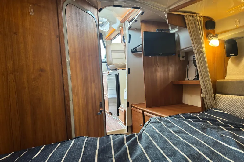Slide: The Image of Interior of 2021 Ranger Tugs R-27 boat with cozy cabin and wooden finishes. - 17