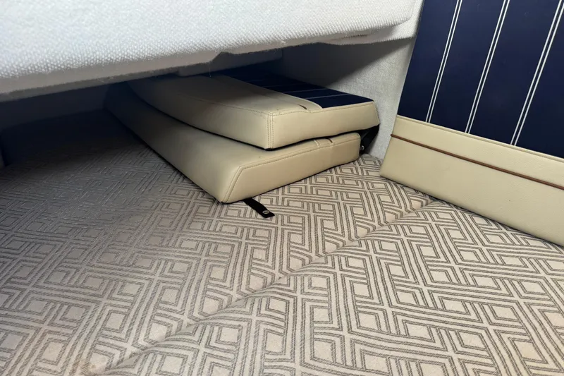 Slide: The Image of Interior view of 2021 Ranger Tugs R-27 with patterned flooring and cushioned seating. - 20