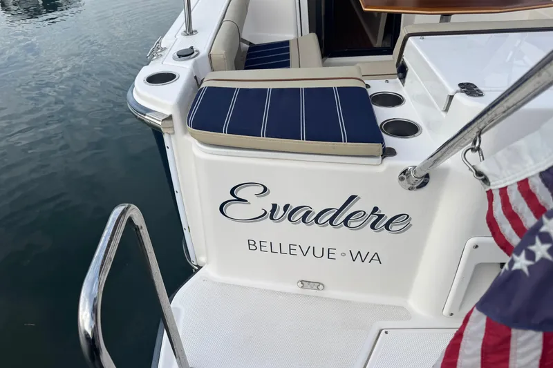 Slide: The Image of 2021 Ranger Tugs R-27 boat named "Evadere" docked in Bellevue, WA with American flag. - 22