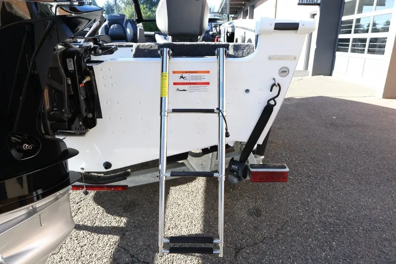 Slide: The Image of 2026 Lund 1875 Crossover XS boat with rear ladder and motor detail. - 10