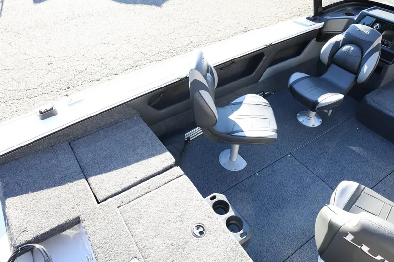 Slide: The Image of 2026 Lund 1875 Crossover XS boat interior with seating and carpeted flooring. - 13