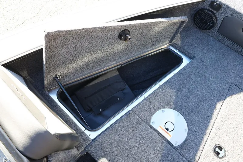 Slide: The Image of 2026 Lund 1875 Crossover XS boat storage compartment with open lid, revealing interior space. - 18