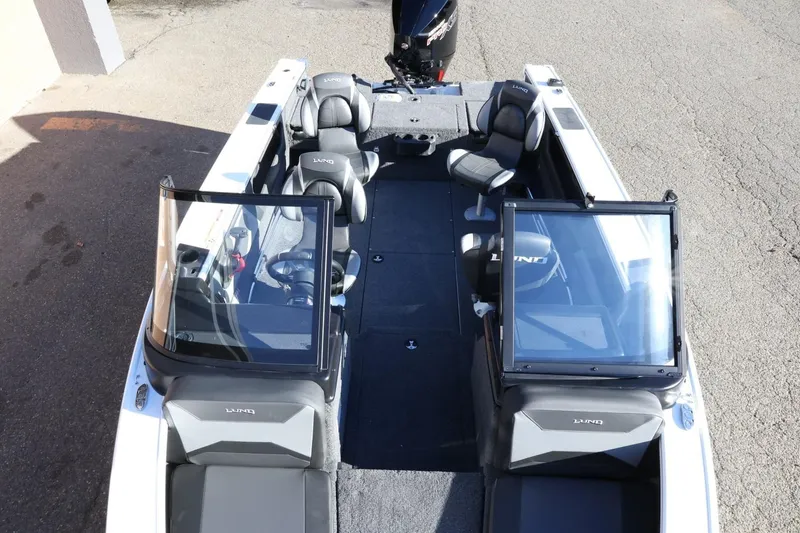 Slide: The Image of 2026 Lund 1875 Crossover XS boat interior with seating and windshield, viewed from above. - 20