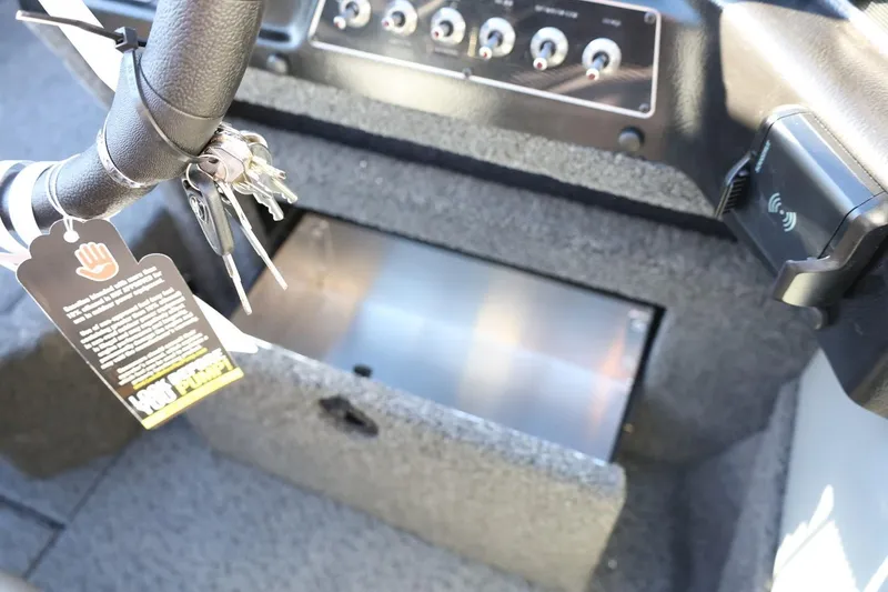 Slide: The Image of Interior of 2026 Lund 1875 Crossover XS boat with keys and control panel. - 29