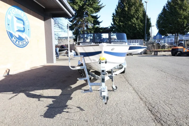 Slide: The Image of 2026 Lund 1875 Crossover XS boat on trailer at Johnson Marine dealership. - 3