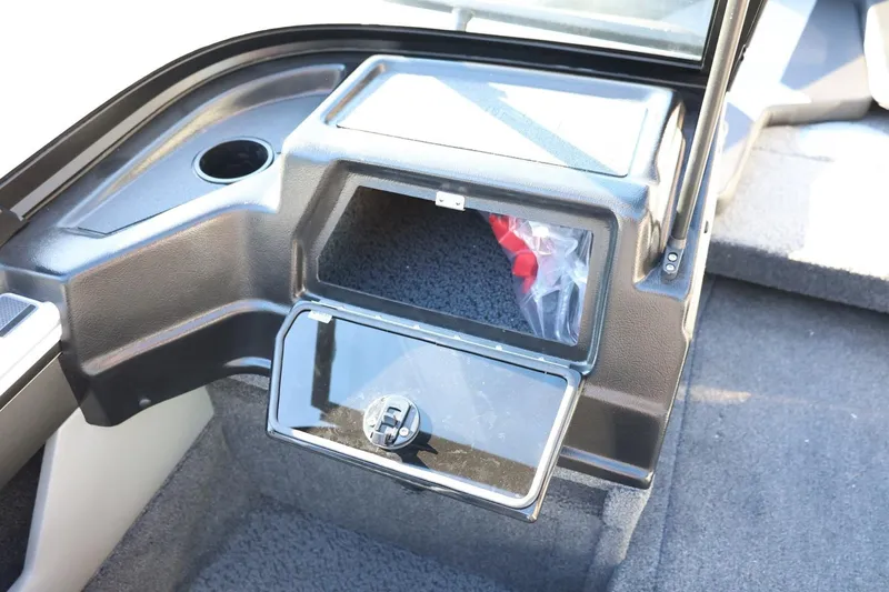 Slide: The Image of Interior of 2026 Lund 1875 Crossover XS boat showing storage compartment and cup holder. - 32