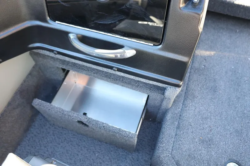 Slide: The Image of 2026 Lund 1875 Crossover XS boat interior storage compartment with open drawer. - 33