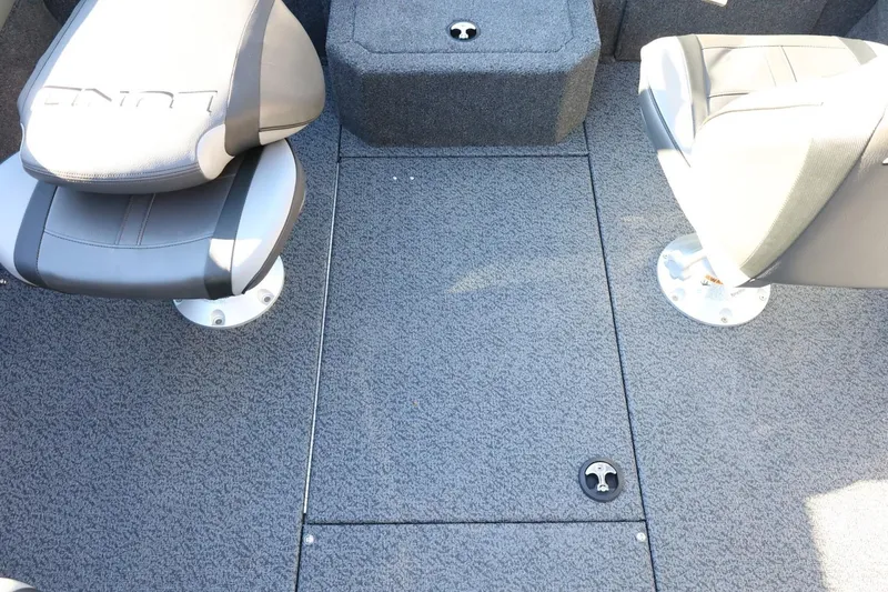 Slide: The Image of 2026 Lund 1875 Crossover XS boat interior with gray seating and carpeted flooring. - 38