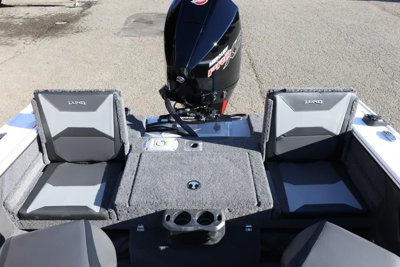 Slide: The Image of 2026 Lund 1875 Crossover XS boat interior with seating and motor. - 41