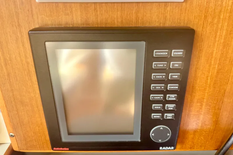 Slide: The Image of Radar display panel on a 1995 Catalina 320 sailboat, featuring various control buttons. - 16