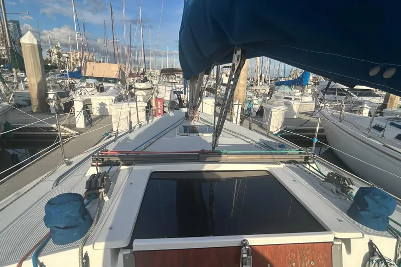 Slide: The Image of Interior of a 1995 Catalina 320 sailboat with blue seating and wooden accents. - 5