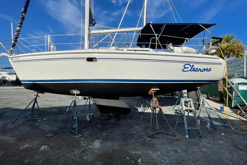 The Image of Sailboat Catalina 310 (2003) navigating under clear skies with vibrant flag. - 0