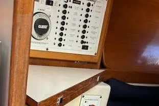 Slide: The Image of Control panel inside a 2003 Catalina 310 sailboat, featuring various switches and a speaker. - 10
