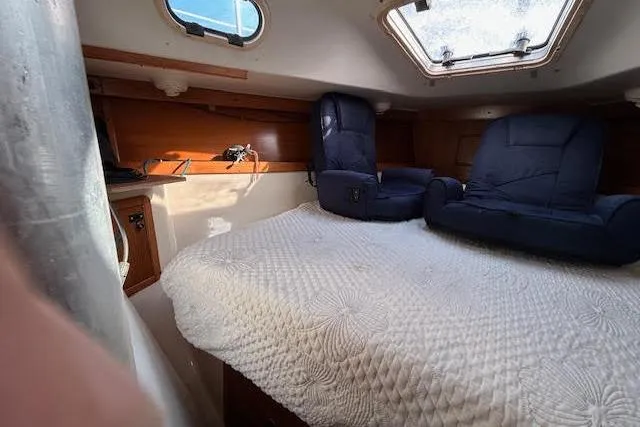 Slide: The Image of Cozy interior of 2003 Catalina 310 sailboat with bed and seating. - 12