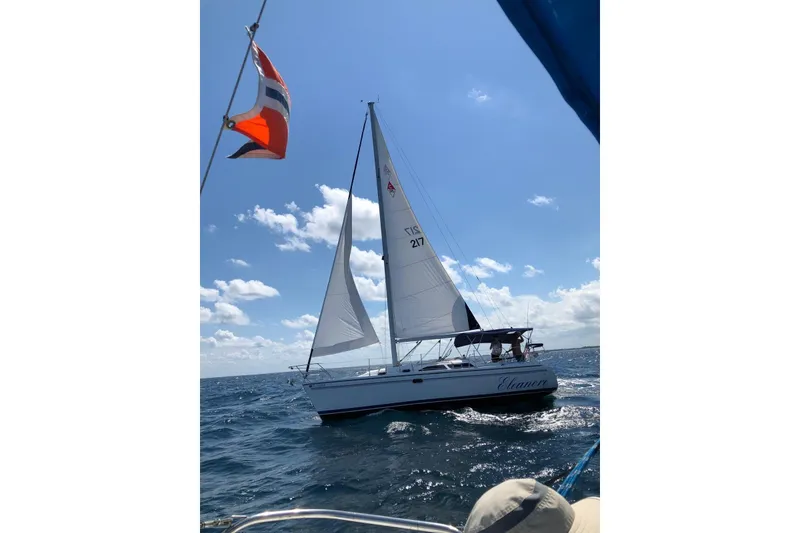 Slide: The Image of 2003 Catalina 310 sailboat docked in West Palm Beach, FL, under a clear blue sky. - 2