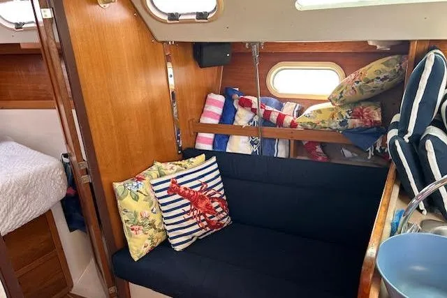 Slide: The Image of Cozy interior of 2003 Catalina 310 sailboat with colorful cushions and wooden accents. - 5