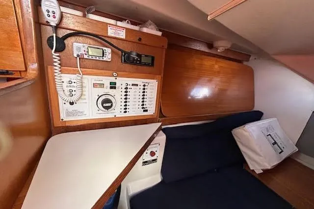 Slide: The Image of Interior of a 2003 Catalina 310 sailboat with navigation equipment and seating area. - 9