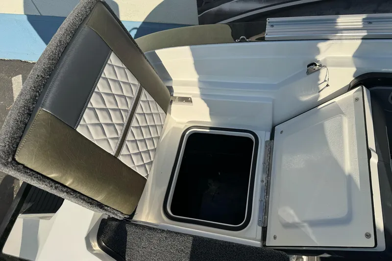Slide: The Image of 2026 Ranger 620xFS Pro boat seat with storage compartment open. - 11