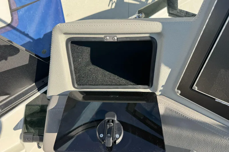 Slide: The Image of Control panel of 2026 Ranger 620xFS Pro boat, featuring a storage compartment. - 13