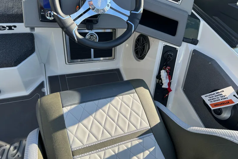 Slide: The Image of 2026 Ranger 620xFS Pro boat interior with steering wheel and quilted seat design. - 18