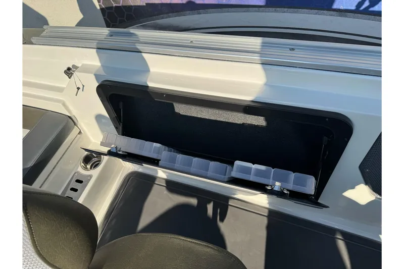 Slide: The Image of 2026 Ranger 620xFS Pro boat storage compartment with organized tackle boxes. - 21