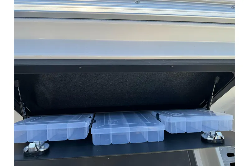 Slide: The Image of Storage compartment of 2026 Ranger 620xFS Pro with clear plastic containers. - 22