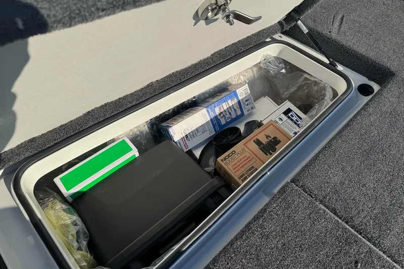 Slide: The Image of Storage compartment in 2026 Ranger 620xFS Pro boat with various items inside. - 25