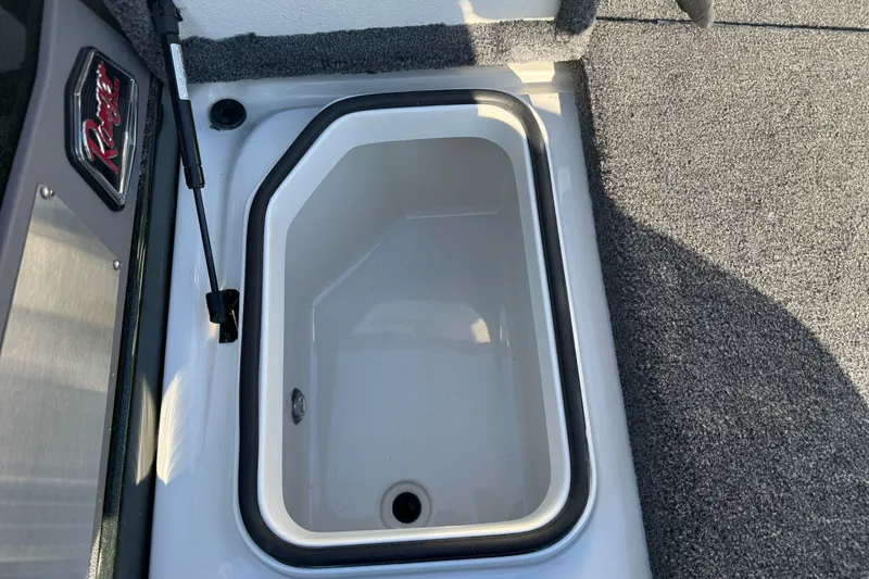 Slide: The Image of 2026 Ranger 620xFS Pro boat storage compartment with carpeted interior. - 26