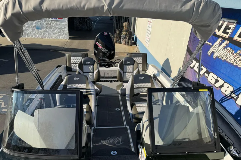 Slide: The Image of 2026 Ranger 620xFS Pro boat with seating and canopy, displayed outdoors. - 28