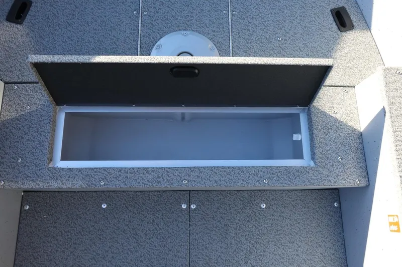 Slide: The Image of Open storage compartment on 2026 Lund 1600 Fury Tiller boat deck. - 13