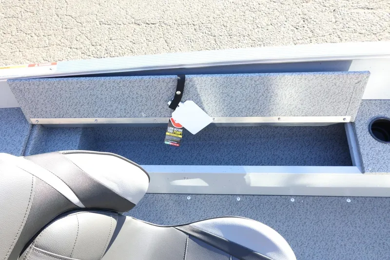 Slide: The Image of 2026 Lund 1600 Fury Tiller boat interior with storage compartment and seating. - 17